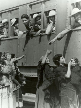 Image of Mexican Braceros, leaving a recruitment center in Mexico and heading to a reception center in U.S., wave goodbye to their families.